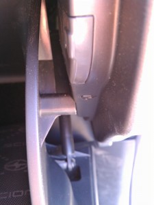 photo of the tab on the right side of the glove box after it's been freed from the groove